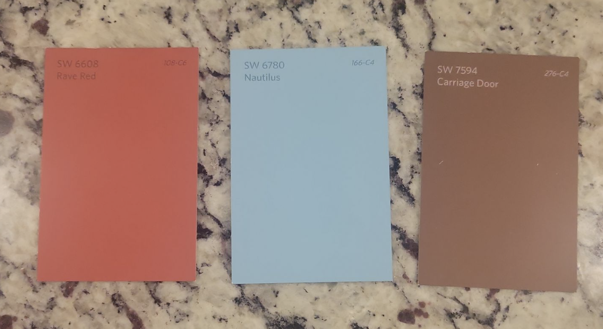 Cabinet color cards and sample options displayed for kitchen color consultation
