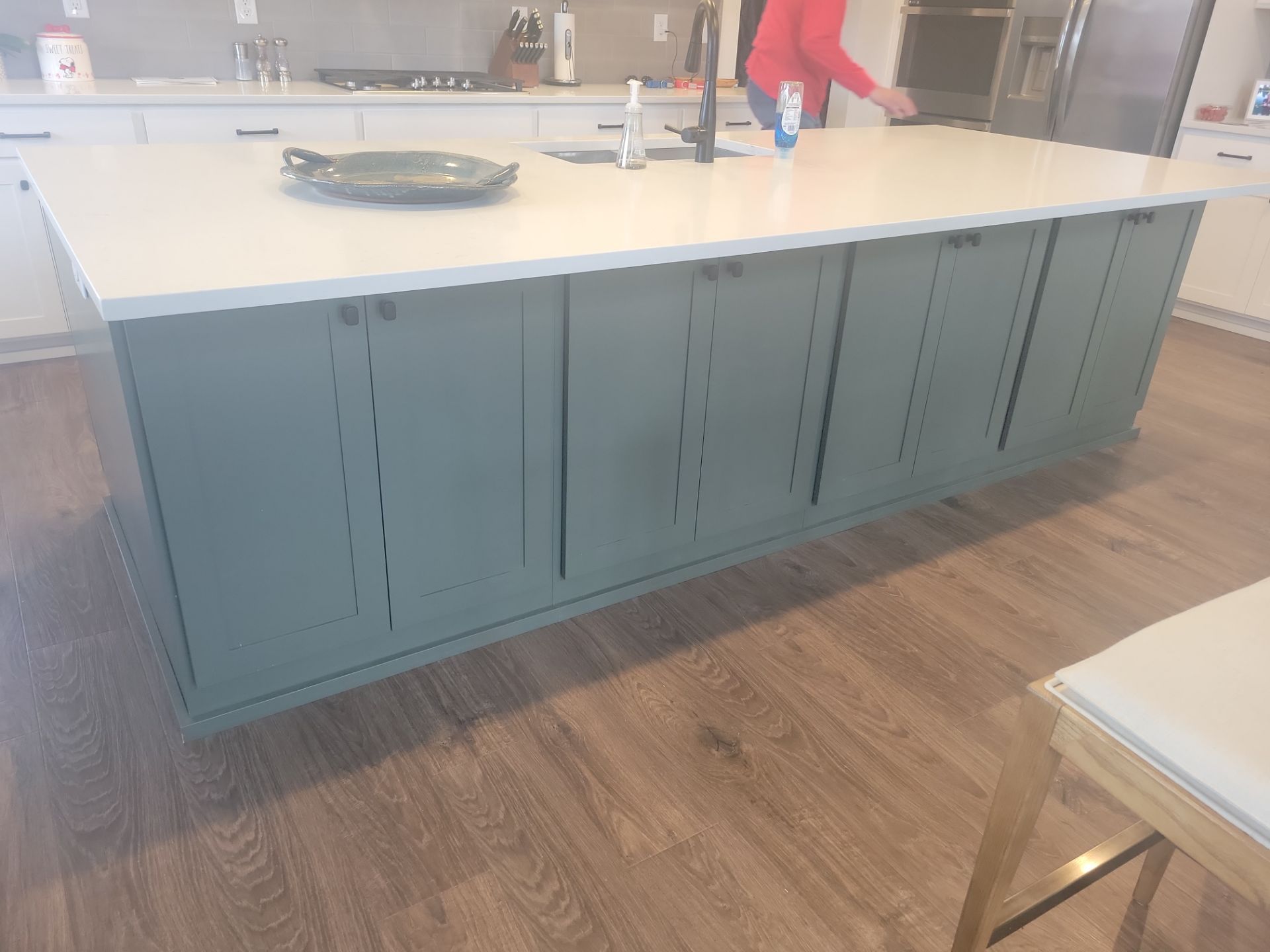 Completed kitchen cabinets in a bold muted blue color in a Utah home
